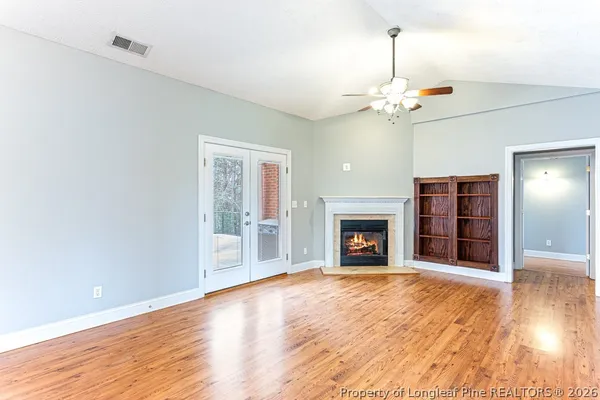 a view of a living room and kitchen with sink