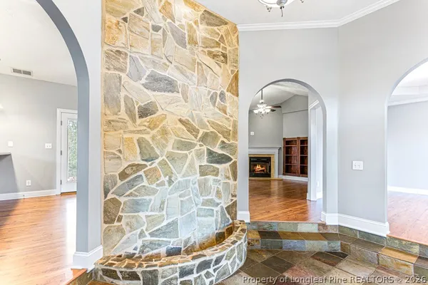 a kitchen with stainless steel appliances granite countertop wooden cabinets a stove a sink and a refrigerator