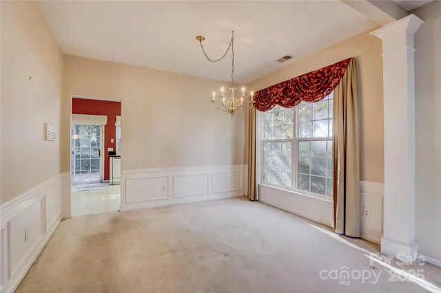 a view of an empty room with glass door