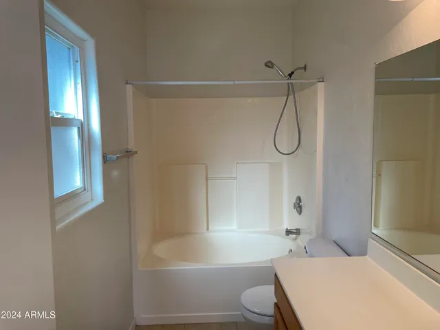 a bathroom with a toilet and a bath tub