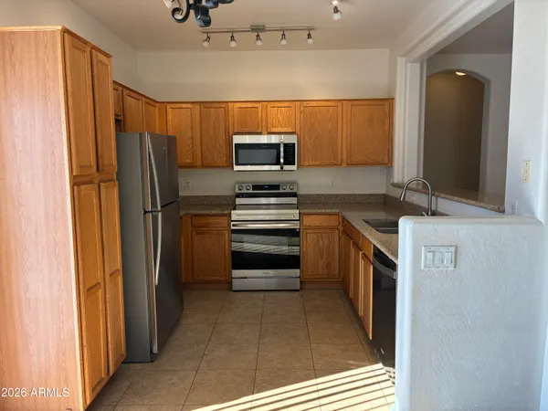 a kitchen with stainless steel appliances a refrigerator and a stove
