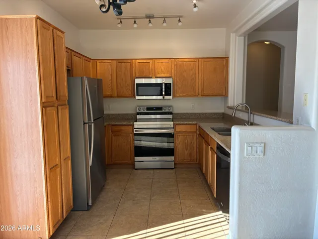 a kitchen with stainless steel appliances a refrigerator and a stove