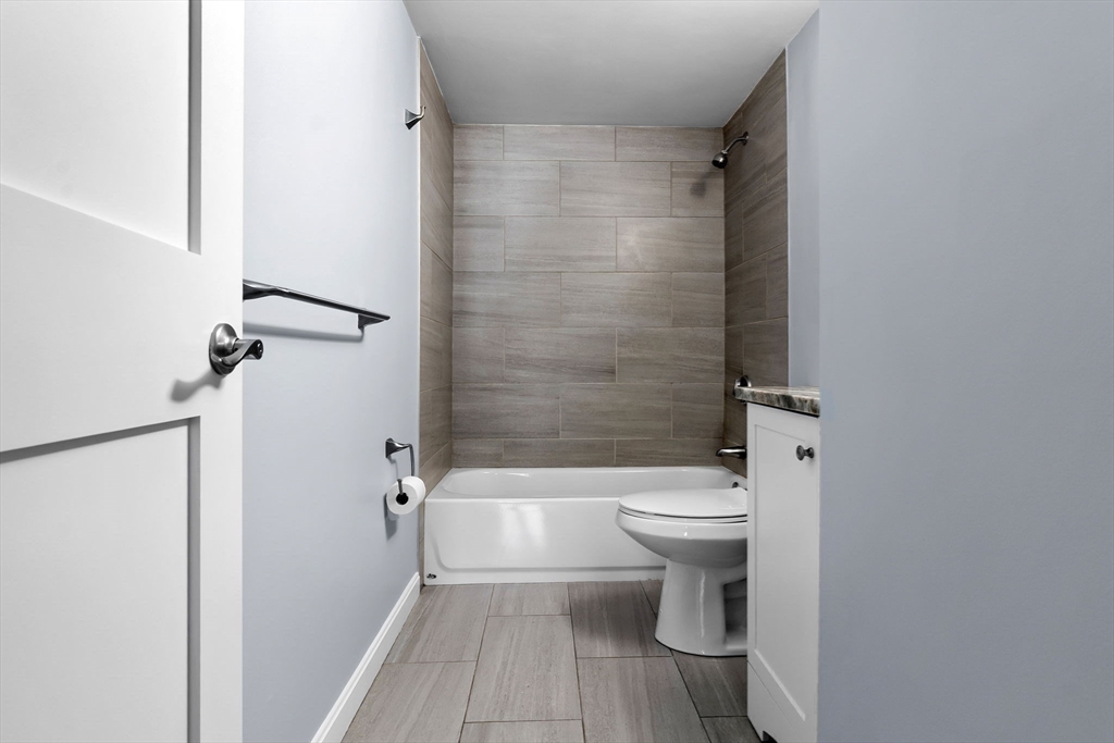 133 Franklin Street, Unit 503 Stoneham, MA 02180 - Photo 12 of 23 a bathroom with a toilet and a shower