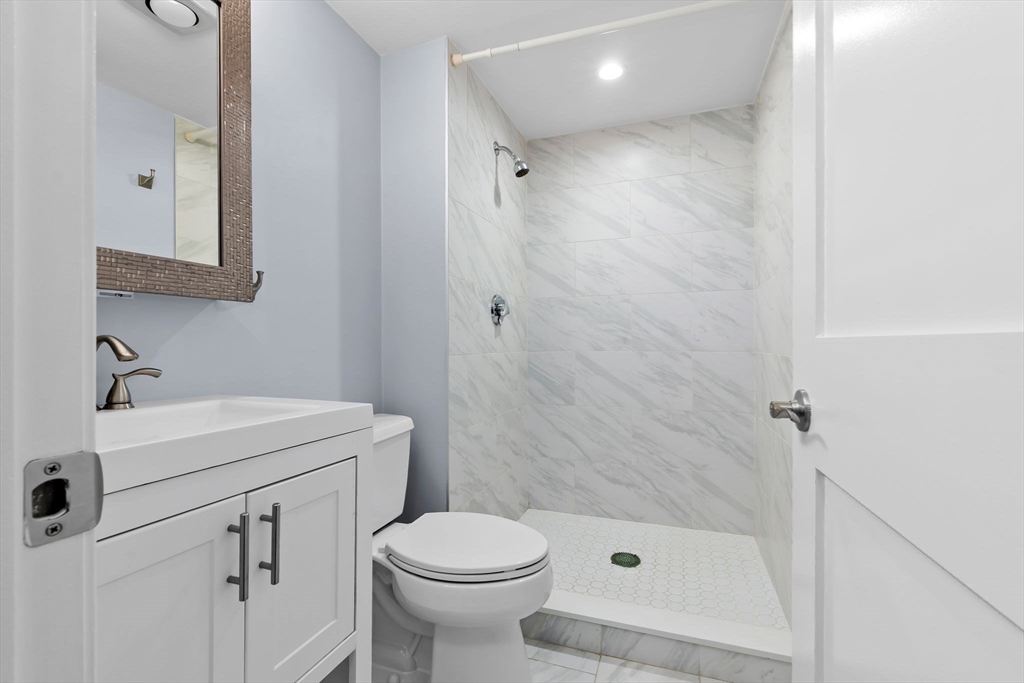 133 Franklin Street, Unit 503 Stoneham, MA 02180 - Photo 15 of 23 a bathroom with a sink a toilet and shower