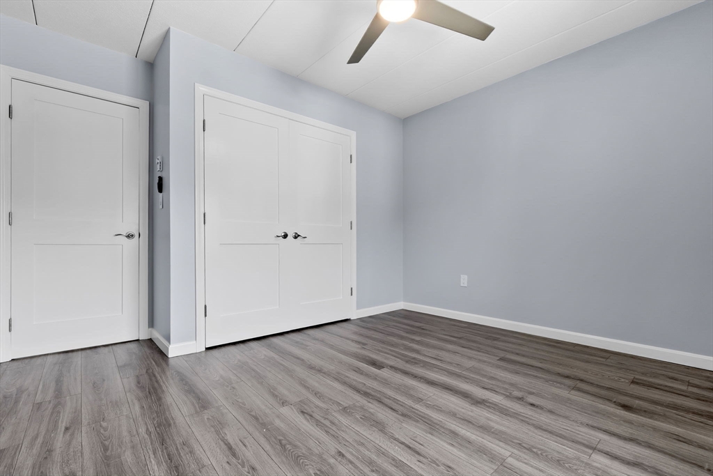 133 Franklin Street, Unit 503 Stoneham, MA 02180 - Photo 17 of 23 a view of an empty room with wooden floor