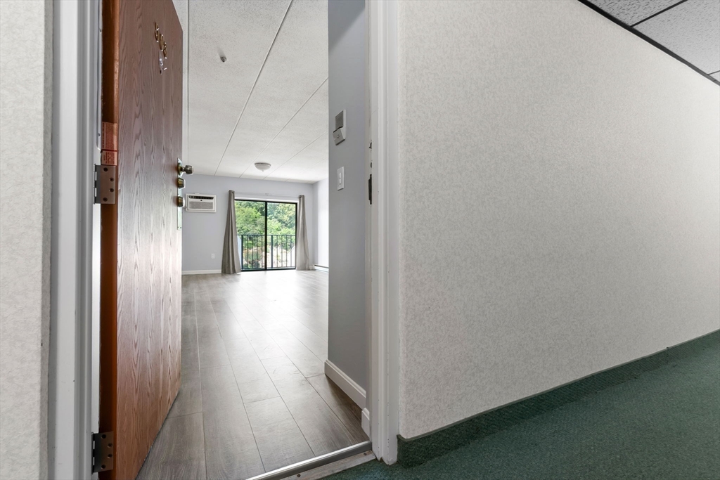 133 Franklin Street, Unit 503 Stoneham, MA 02180 - Photo 20 of 23 a view of a hallway with wooden floor