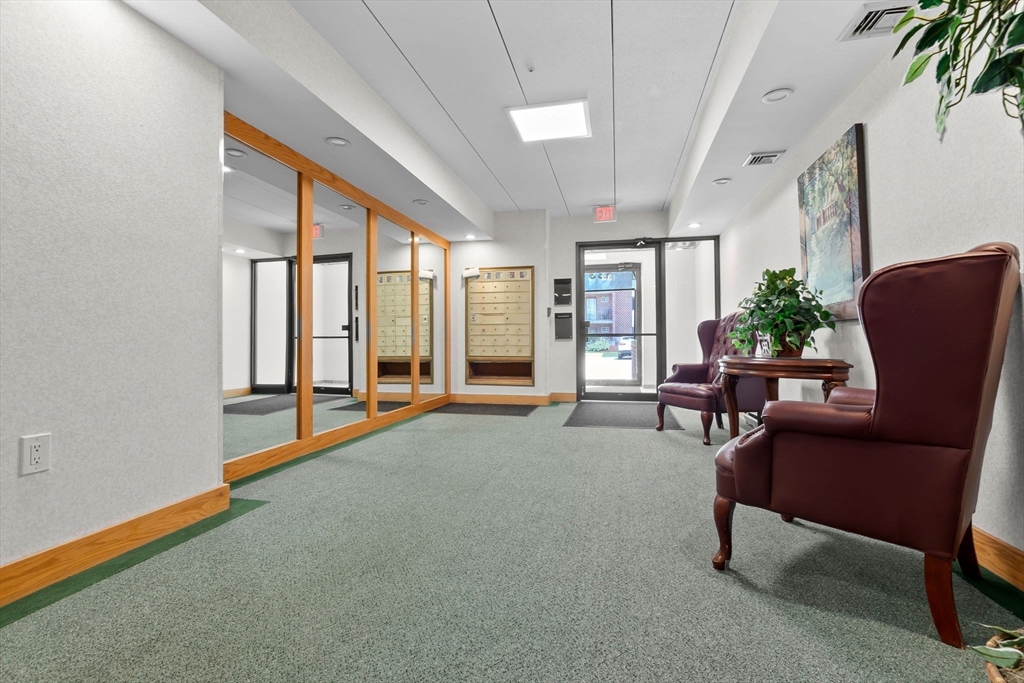 133 Franklin Street, Unit 503 Stoneham, MA 02180 - Photo 22 of 23 a living room with furniture and a large window