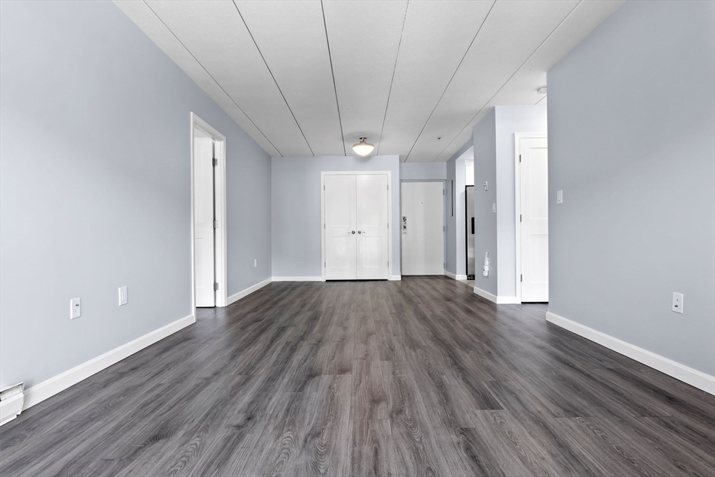 133 Franklin Street, Unit 503 Stoneham, MA 02180 - Photo 6 of 23 a view of a room with wooden floors and led lights