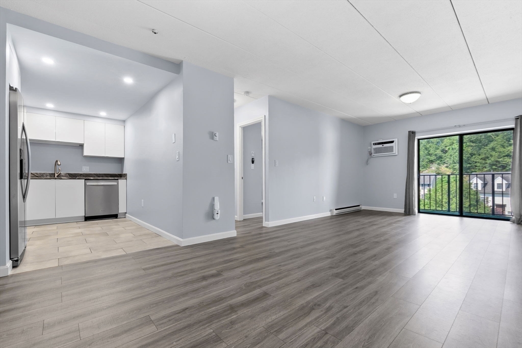 133 Franklin Street, Unit 503 Stoneham, MA 02180 - Photo 9 of 23 a view of kitchen with wooden floor and electronic appliances