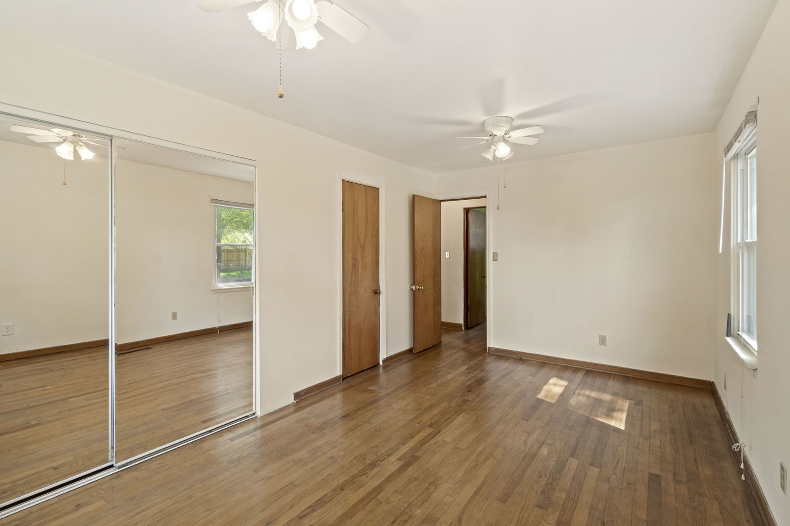 1548 South 5th Avenue Kankakee, IL 60901 - Photo 9 of 18 wooden floor in an empty room with a window