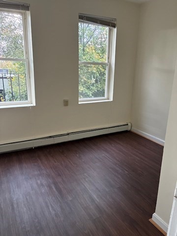 59 South Huntington Avenue, Unit 8 Boston, MA 02130 - Photo 5 of 5 an empty room with wooden floor and windows