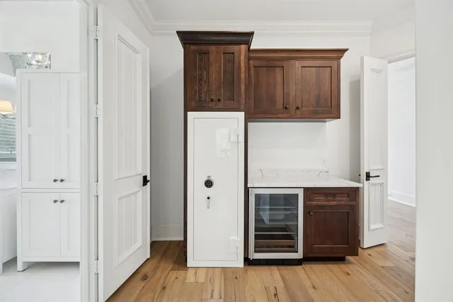 a view of a hallway with wooden floor and closet