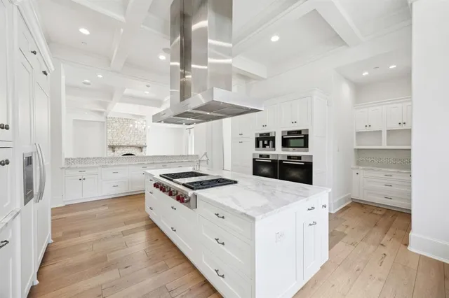a kitchen with stainless steel appliances granite countertop a stove and a refrigerator