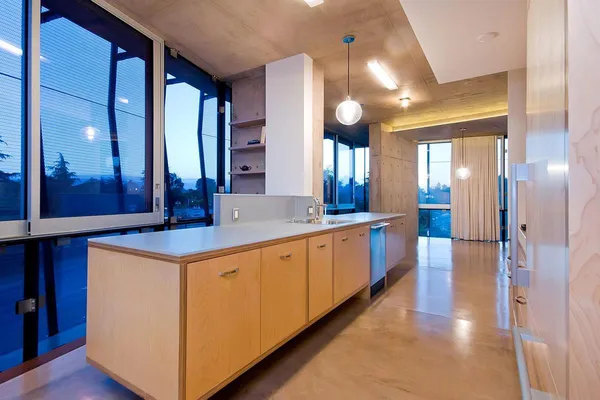 a large kitchen with a lot of counter space and glass door