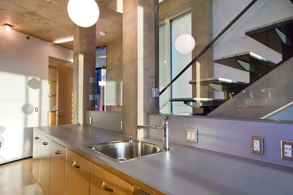 a kitchen with sink and mirror