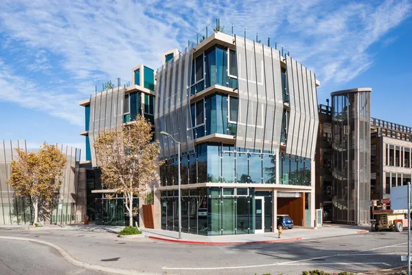 a front view of a building with trees