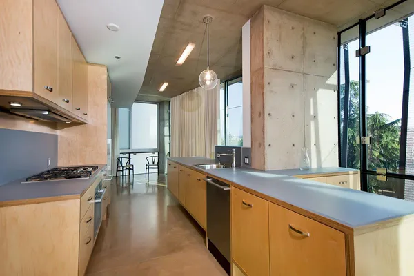a kitchen with stainless steel appliances a sink stove and cabinets