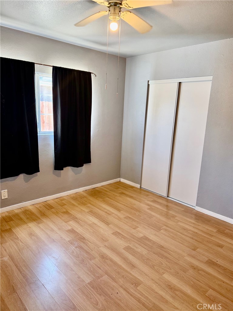 12931 Fourth Street Chino, CA 91710 - Photo 12 of 34 a bedroom with a bed and a chandelier