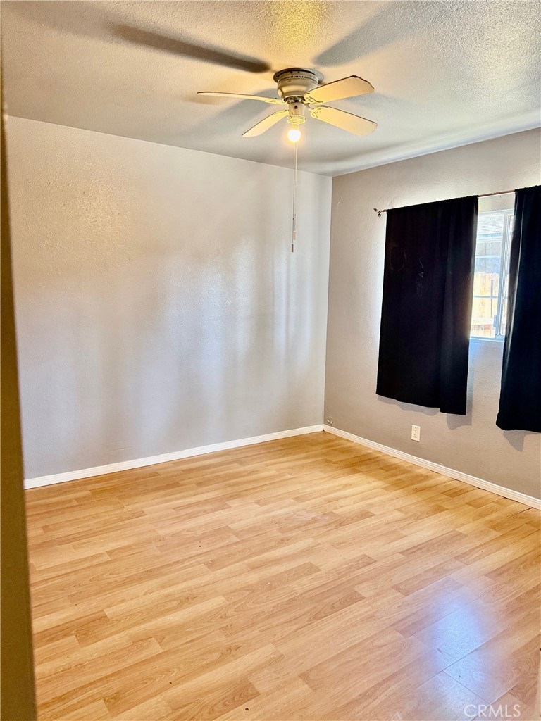 12931 Fourth Street Chino, CA 91710 - Photo 13 of 34 a view of an empty room with wooden floor