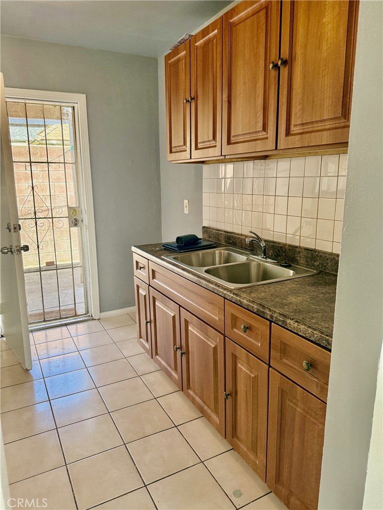 12931 Fourth Street Chino, CA 91710 - Photo 21 of 34 a kitchen with granite countertop a sink and a stove
