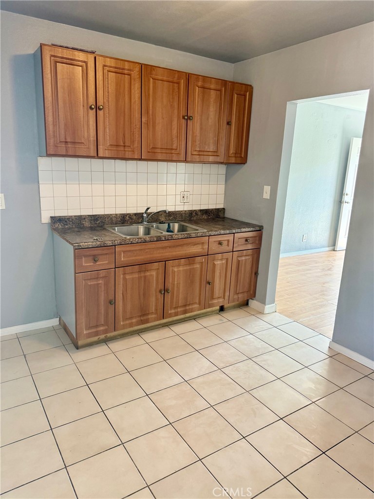 12931 Fourth Street Chino, CA 91710 - Photo 22 of 34 a kitchen with stainless steel appliances granite countertop a stove a sink and a refrigerator