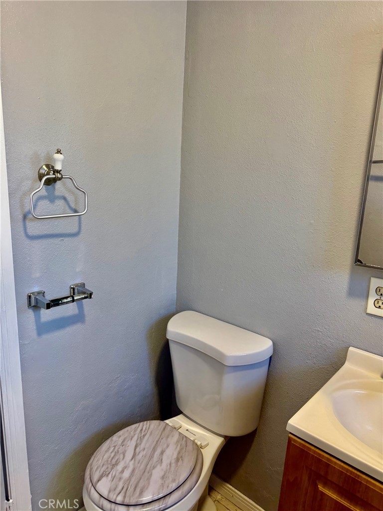 12931 Fourth Street Chino, CA 91710 - Photo 31 of 34 a white toilet sitting next to a bathroom sink