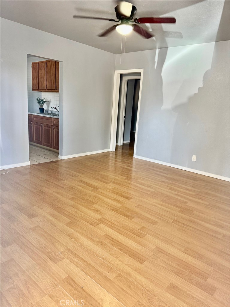 12931 Fourth Street Chino, CA 91710 - Photo 5 of 34 a view of an empty room with wooden floor and a ceiling fan