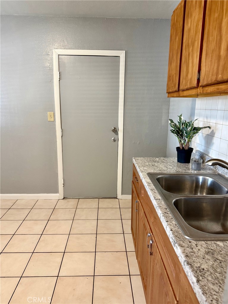 12931 Fourth Street Chino, CA 91710 - Photo 9 of 34 a kitchen with a sink and cabinets