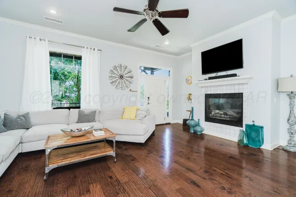 a living room with furniture fireplace and flat screen tv