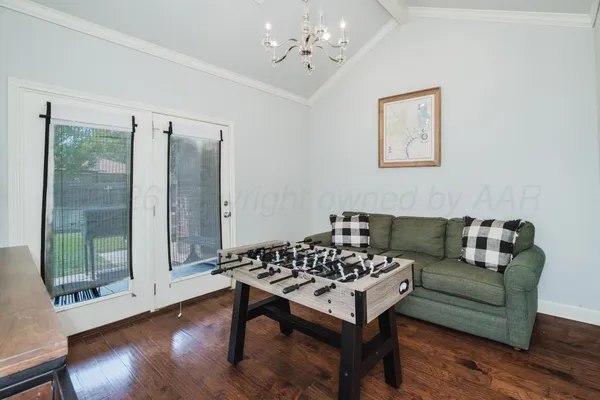 a living room with furniture a table and wooden floor
