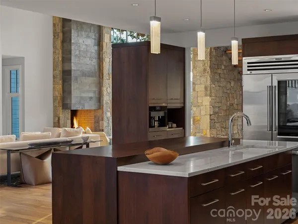 a kitchen with stainless steel appliances a sink stove and refrigerator