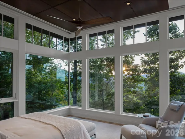 a bedroom with a large bed and a large window