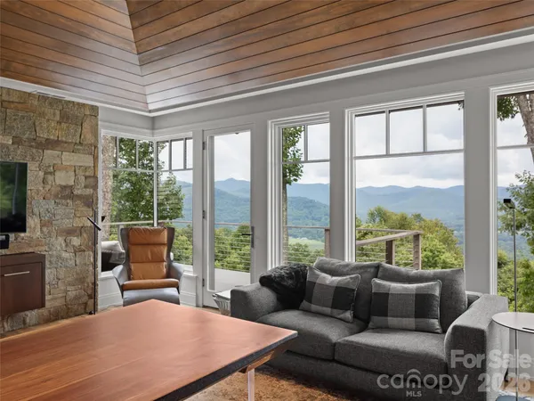 a living room with furniture and a floor to ceiling window