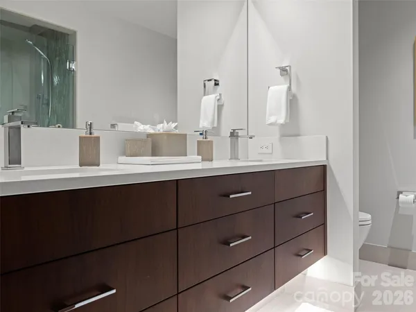 a bathroom with a double vanity sink and a mirror
