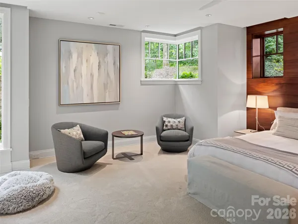 a bedroom with furniture and a window