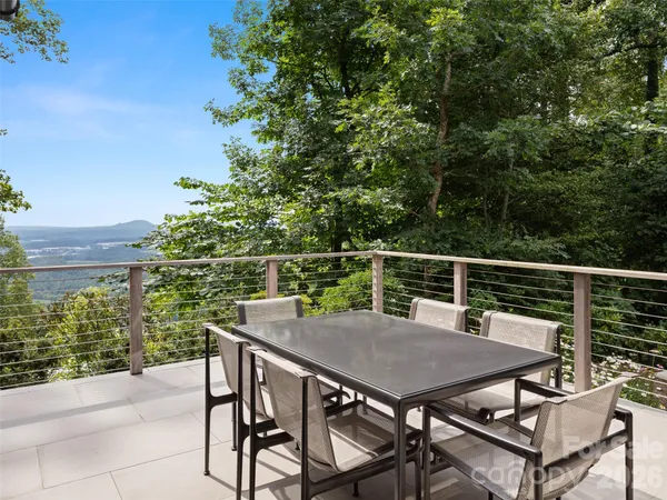 a balcony with a table and chairs