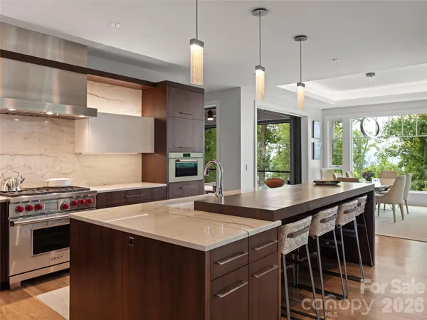 a kitchen with a stove and a wooden floor