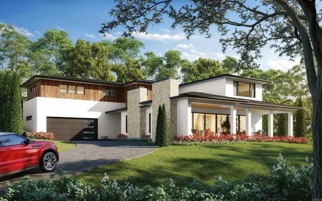 a front view of a house with a garden