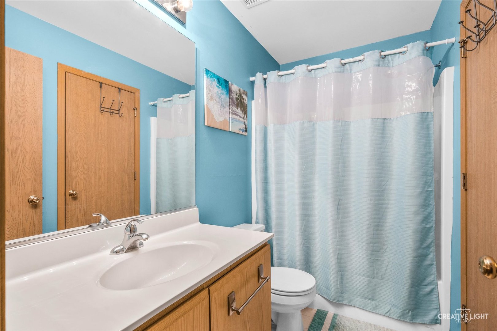 1517 Azalea Circle Romeoville, IL 60446 - Photo 11 of 19 a bathroom with a sink a toilet and shower curtain