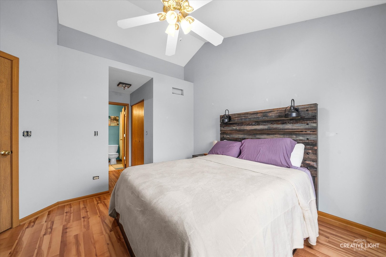 1517 Azalea Circle Romeoville, IL 60446 - Photo 12 of 19 a bedroom with a bed and a chandelier