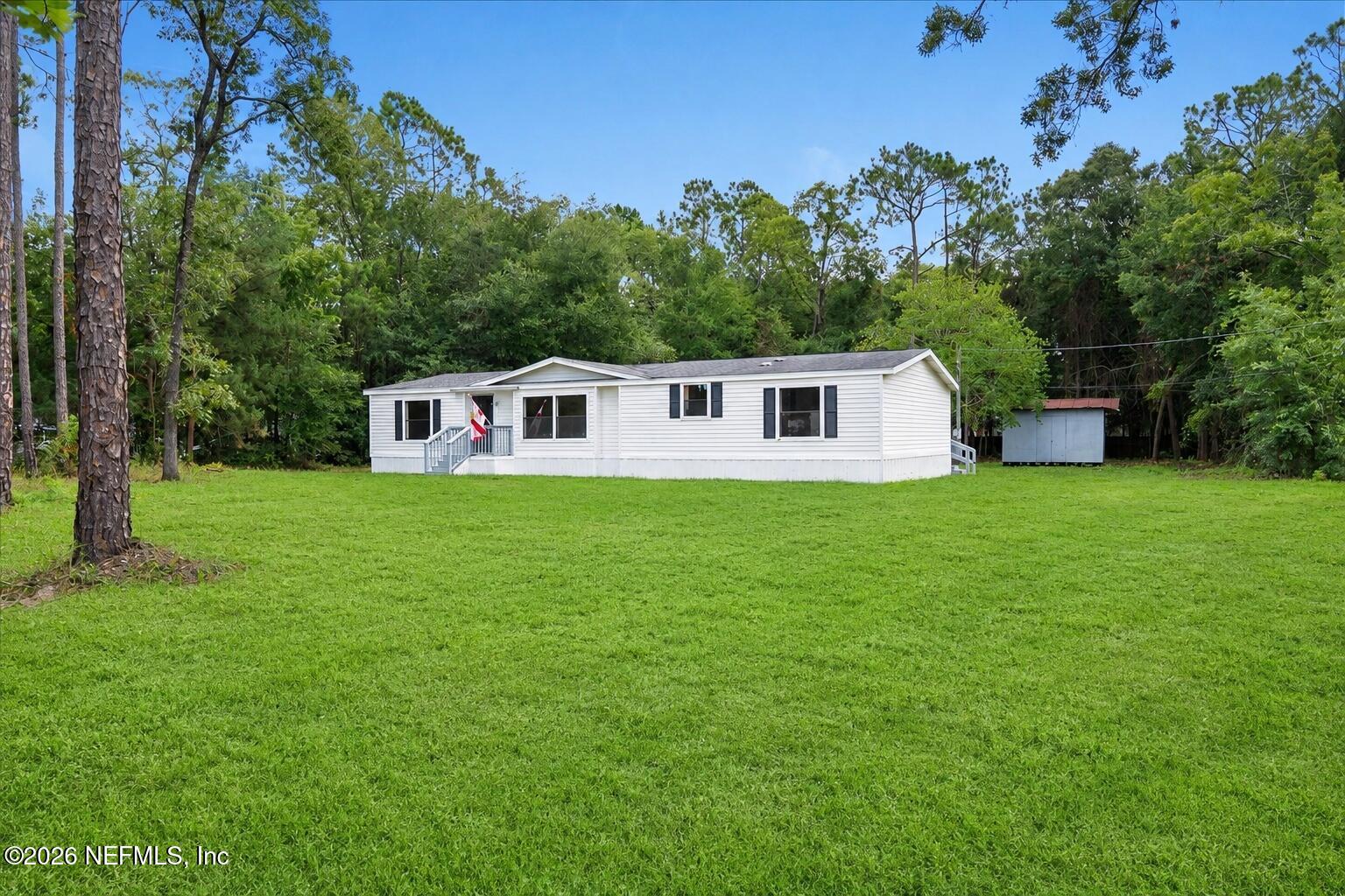 85110 Theresa Road Yulee, FL 32097 - Photo 2 of 43 02_Updated_Front_Wide_Lawn