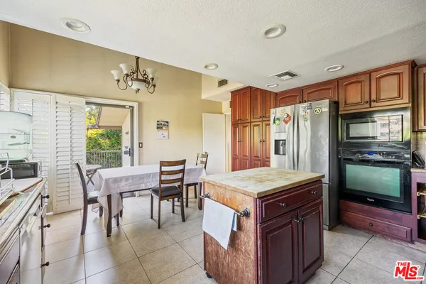 a room with a table chairs and entryway