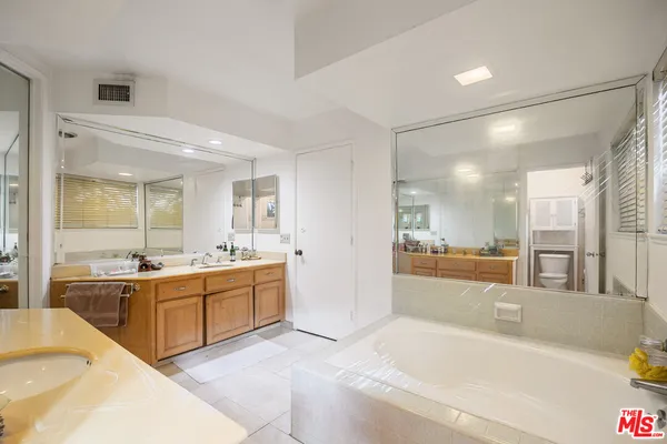 a large bathroom with a large tub and sink