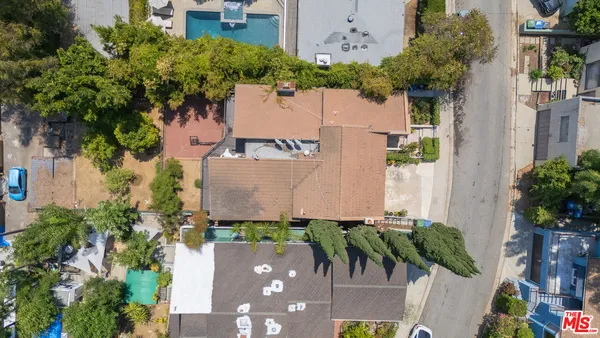an aerial view of a house with a yard and a fountain
