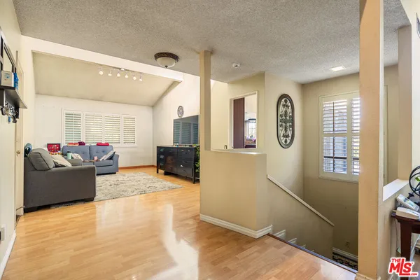 a living room with furniture window and wooden floor