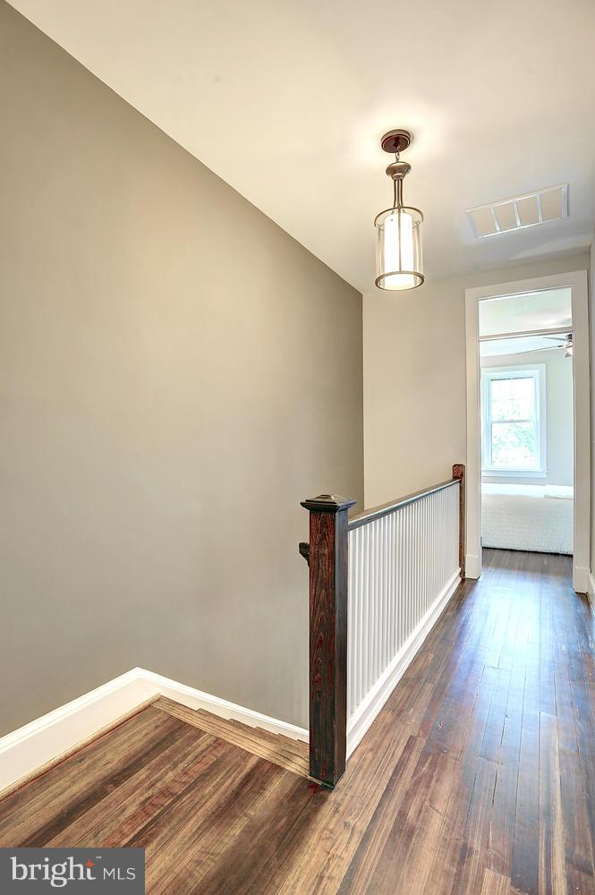17 16th Street Southeast Washington, DC 20003 - Photo 13 of 29 a view of a hallway with wooden floor and chandelier