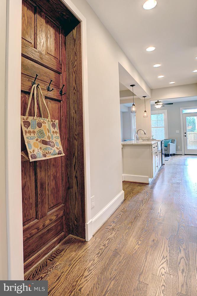 17 16th Street Southeast Washington, DC 20003 - Photo 5 of 29 a view of a hallway with wooden floor windows and a kitchen view
