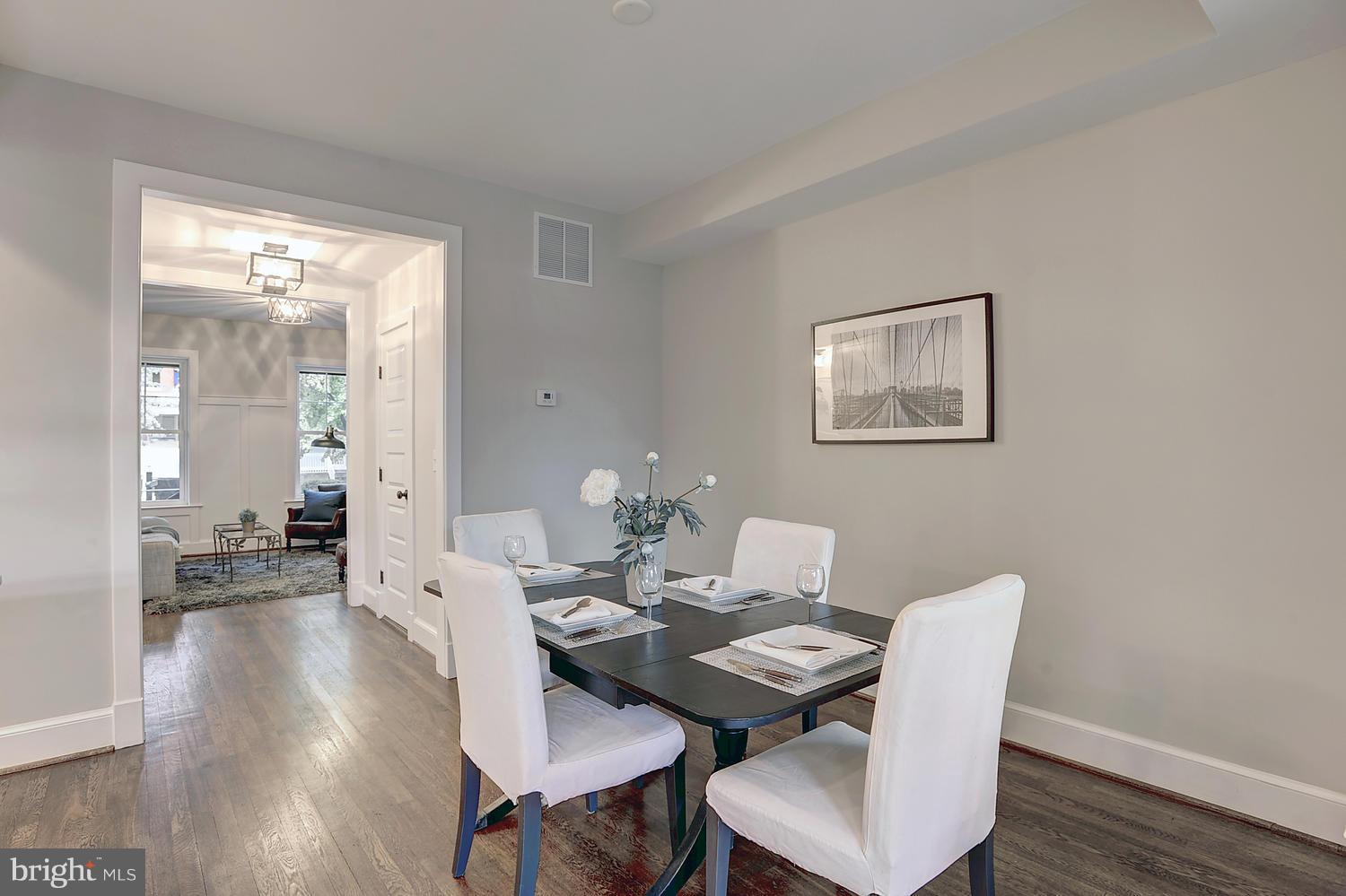 17 16th Street Southeast Washington, DC 20003 - Photo 7 of 29 a view of a dining room with furniture wooden floor and a chandelier