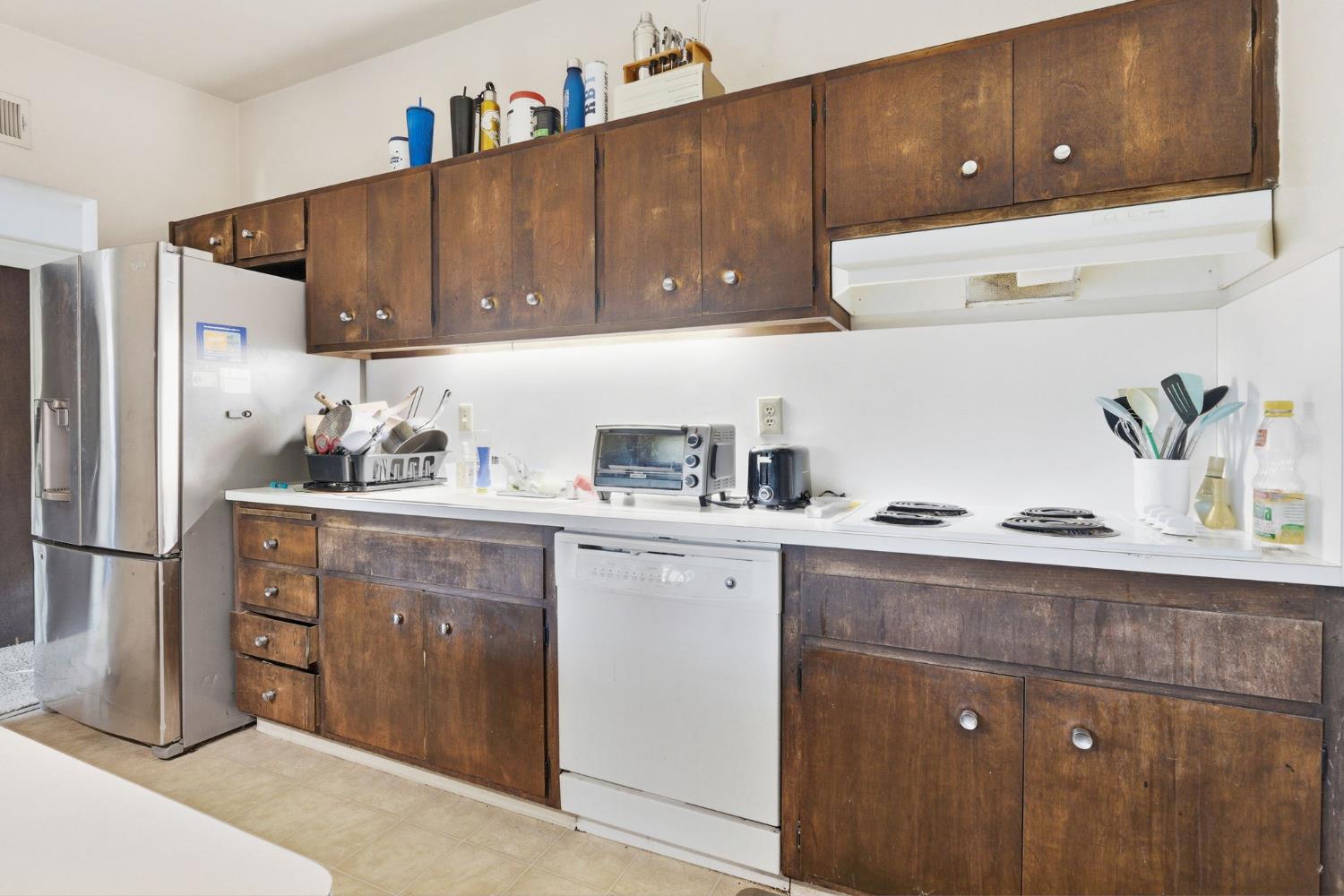 916 Drake Drive Davis, CA 95616 - Photo 12 of 19 a kitchen with a sink a refrigerator and cabinets