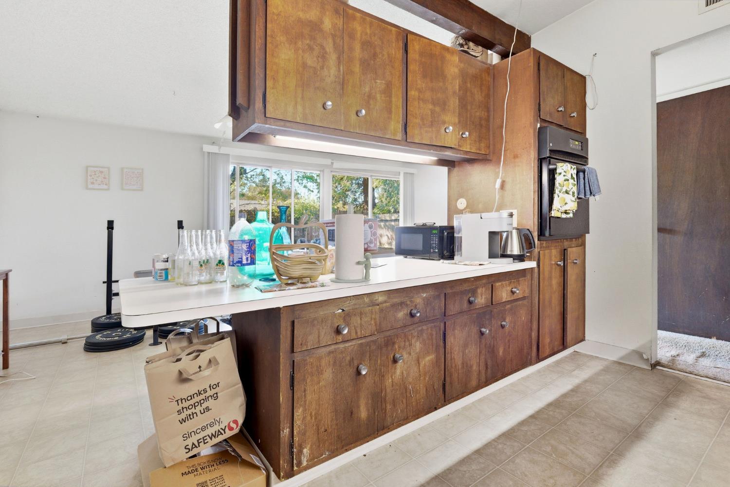 916 Drake Drive Davis, CA 95616 - Photo 13 of 19 a kitchen with a sink cabinets and window